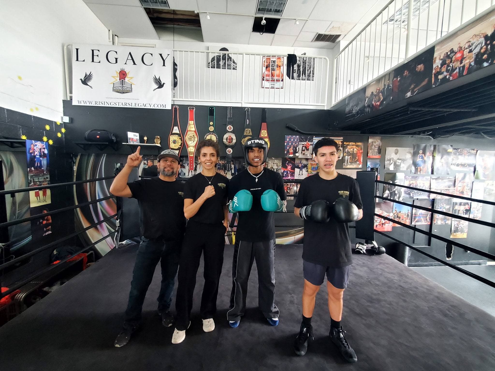 The team by the Legacy banner at the gym