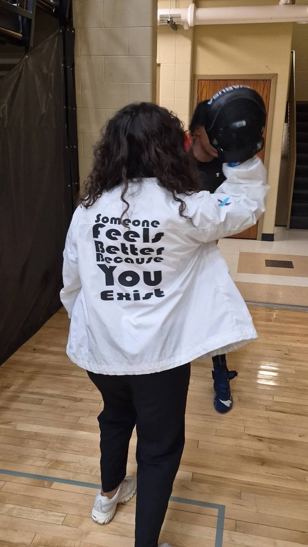 A Vargas boxer carrying her headgear across the gym floor