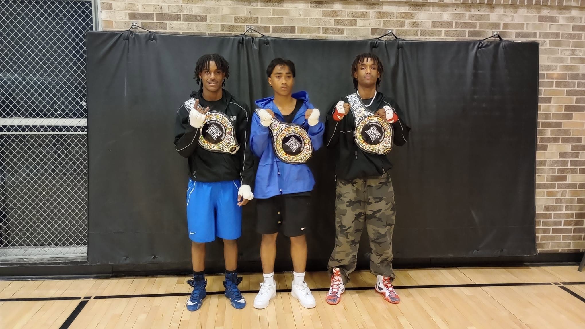 Three young Vargas champions with their belts