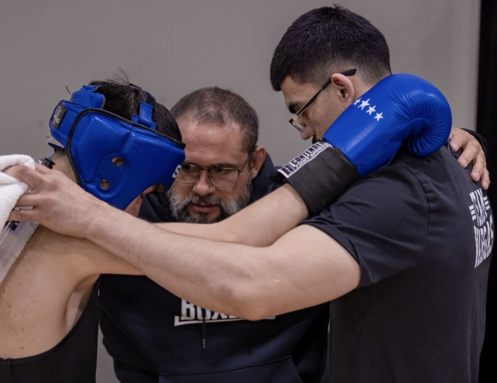 Coach Vargas and his fighters together in prayer at Vargas Boxing
