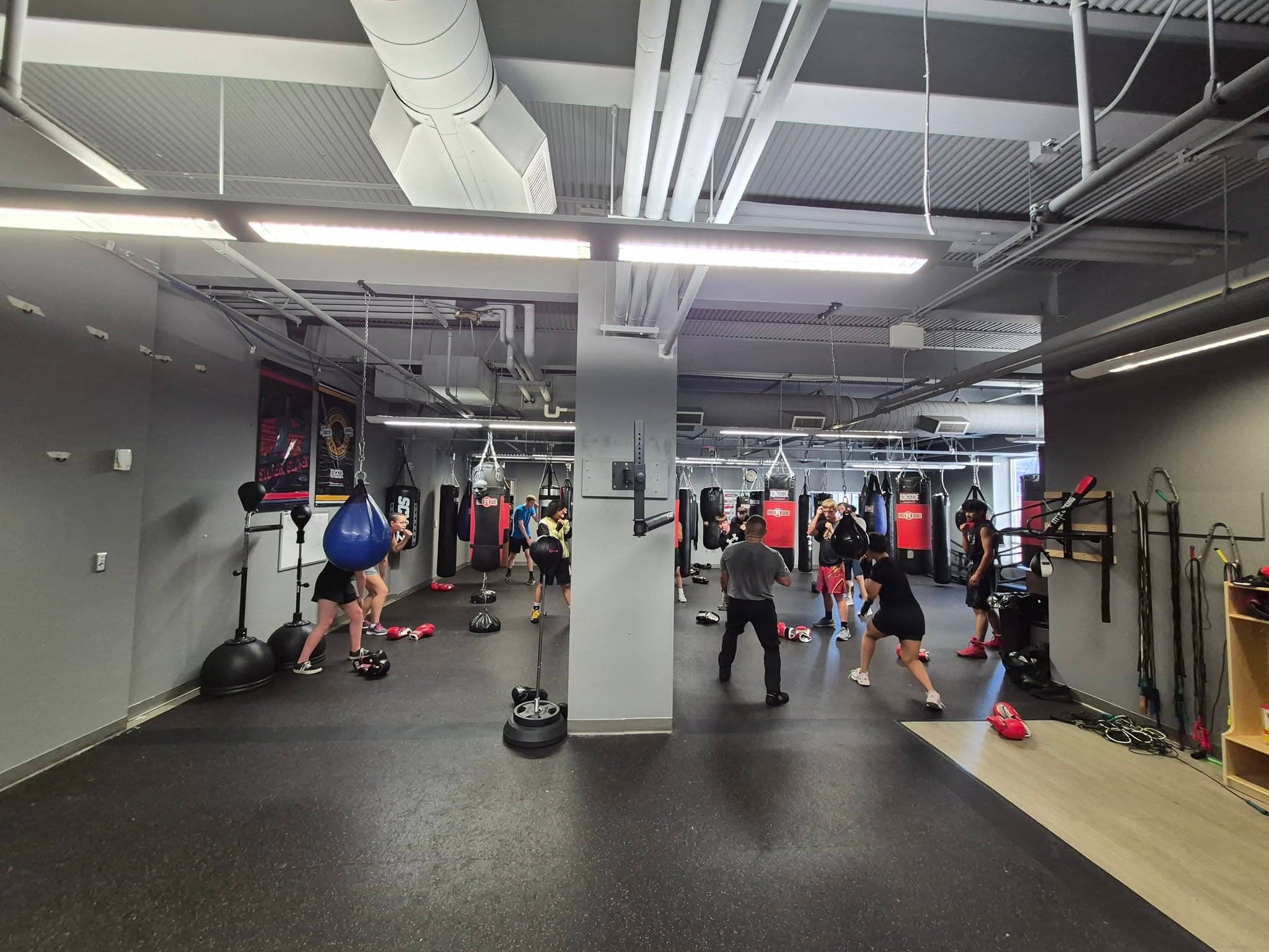 Boxers working the heavy bags on the Vargas Boxing training floor